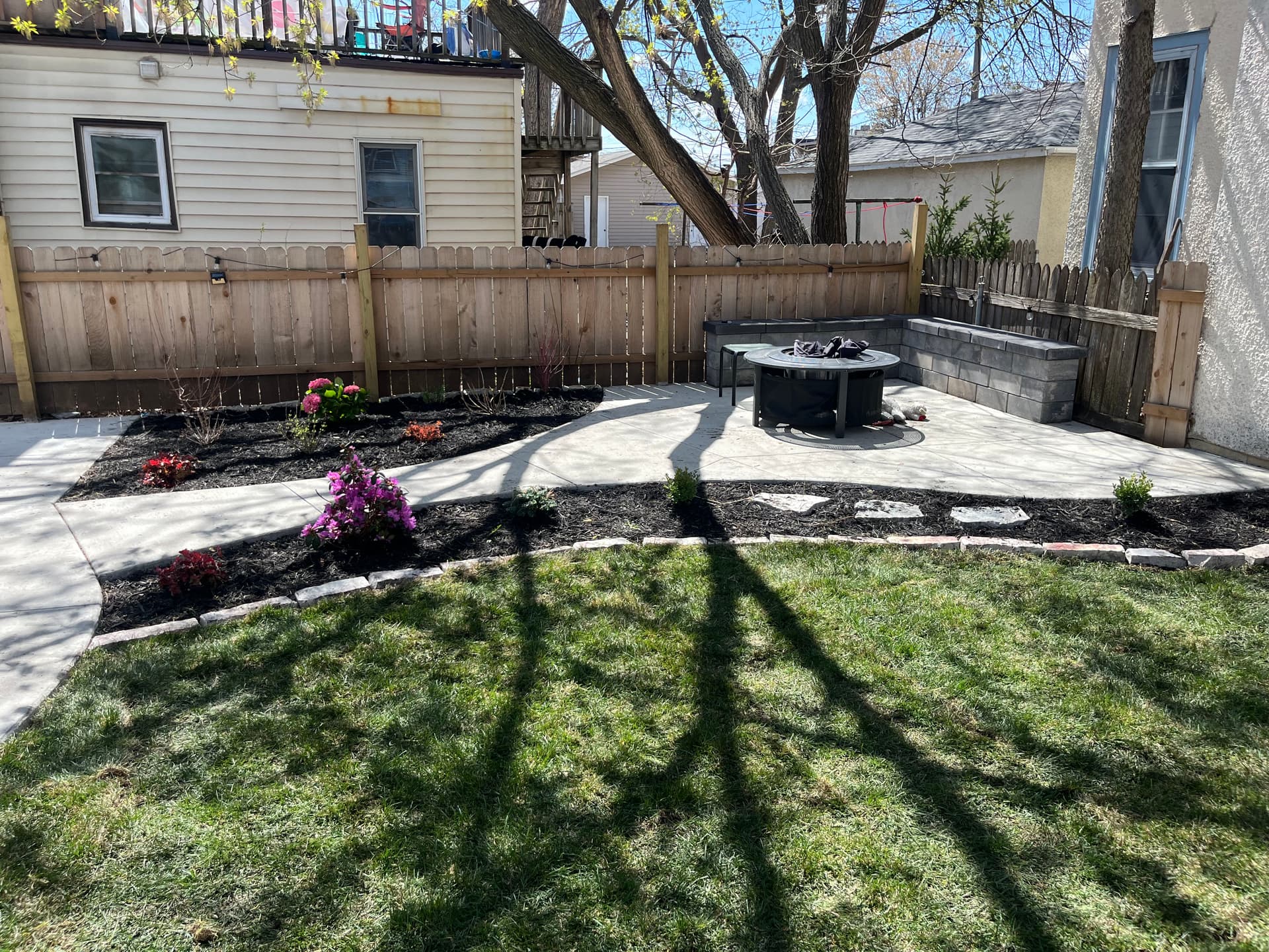 Minneapolis Backyard Gets a Concrete Patio, Sod, and Plant Beds